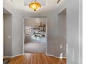 Open entryway leading to a carpeted living room with custom shelving at 2414 Winding Dr, Longmont, CO 80504