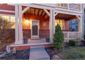 Inviting front porch with brick accents and manicured landscaping at 2414 Winding Dr, Longmont, CO 80504