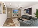 Elegant living room with a fireplace, modern lighting, and a large window providing natural light at 25127 E Maple Ave, Aurora, CO 80018