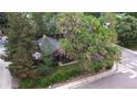 An aerial view of the cozy home nestled among mature trees on a residential street at 1703 W Weaver Ave, Littleton, CO 80120