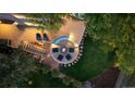 Elevated deck with fire pit and seating area at night at 3780 Lakebriar Dr, Boulder, CO 80304