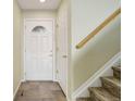 Entryway with tile flooring, a decorative front door, and a staircase leading upstairs at 10364 Ravenswood Way, Highlands Ranch, CO 80130
