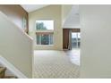Spacious living room featuring high ceilings, large windows, and neutral carpet at 10364 Ravenswood Way, Highlands Ranch, CO 80130