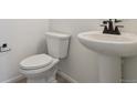 Small bathroom with pedestal sink and a toilet at 24520 E 36Th Ave, Aurora, CO 80019