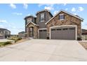 Two-story home with stone and gray siding, two-car garage at 2614 Hillcroft Ln, Castle Rock, CO 80104