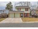 Lovely two-story home with red shutters, a well-kept lawn, and a convenient two-car garage at 8155 Everett E St, Arvada, CO 80005