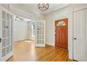 Bright foyer with hardwood floors, detailed trim, glass paneled doors, and a classic chandelier at 351 Bannock St, Denver, CO 80223