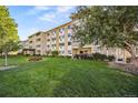 Low-rise residential condo building with well-maintained lawn and verdant landscaping at 610 S Alton Way # 7C, Denver, CO 80247