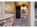 Close up of front door with stone accents and craftsman style at 2633 Garganey Dr, Castle Rock, CO 80104