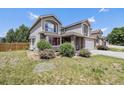 Two story home with neutral color scheme, brick accents, and a well maintained lawn and garden at 17464 Crestview Ct, Monument, CO 80132