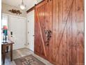 Welcoming foyer featuring a decorative sliding barn door and durable wood-look flooring at 7344 S Sheephorn Mtn, Littleton, CO 80127