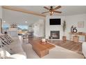 Bright living room featuring a fireplace, hardwood floors, and contemporary furnishings at 7686 County Road 21, Fort Lupton, CO 80621