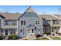 Charming townhome with eye-catching blue facade, stylish trim, and inviting entrance at 9659 W Cornell Pl, Lakewood, CO 80227