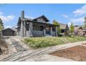 Charming single-Gathering home with a well-manicured lawn and an inviting covered front porch at 2659 Ash St, Denver, CO 80207