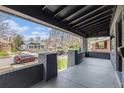 Relaxing covered porch with brick pillars and a view of the street and neighborhood at 2659 Ash St, Denver, CO 80207