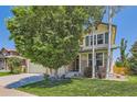 Beautiful two-story home with a well-manicured lawn, mature trees, and charming curb appeal at 13962 Dexter Way, Thornton, CO 80602