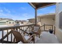 Relaxing covered front porch with comfortable wicker chairs to enjoy the outdoors at 4078 Happy Hollow Dr, Castle Rock, CO 80104