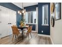 Cozy dining room with modern chandelier, table, and stylish chairs at 3830 Jason St # 4, Denver, CO 80211