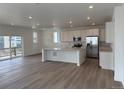This spacious kitchen offers white cabinets, stainless steel appliances, and an open-concept layout with great natural light at 7276 Waterleaf Trl, Littleton, CO 80125