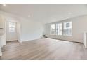 Spacious living room with hardwood floors and plenty of windows for natural light at 7276 Waterleaf Trl, Littleton, CO 80125