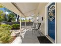 Inviting covered front porch with seating area, perfect for relaxing and enjoying the outdoors at 1253 Uinta St, Denver, CO 80220