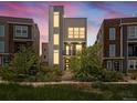 Contemporary home with striking architecture and attractive landscaping at twilight at 3654 Penang Dr, Castle Rock, CO 80109