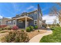 Charming two-story home with blue siding, stone accents, and a landscaped front yard at 671 Robert St, Longmont, CO 80503