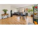 Spacious living room with hardwood floors, large windows, and comfortable seating at 671 Robert St, Longmont, CO 80503