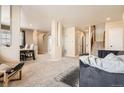 Spacious living room with plush carpeting, neutral walls, and comfortable seating at 12185 S Grass River Trl, Parker, CO 80134