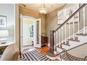Inviting foyer featuring a staircase, wooden floors, and decorative lighting fixture at 434 N Washington St, Denver, CO 80203