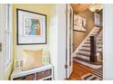 Bright foyer with hardwood floors, stairs, and a cozy bench with storage at 434 N Washington St, Denver, CO 80203