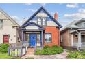 Charming brick home with blue front door and well-maintained landscaping at 434 N Washington St, Denver, CO 80203