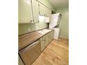 Kitchen featuring stainless dishwasher and in-unit washer and dryer at 7309 W Hampden Ave # 5202, Lakewood, CO 80227