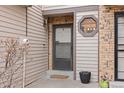 Close-up of an inviting front entryway featuring a brick accent and octagon window at 871 S Joplin Cir, Aurora, CO 80017