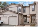 Charming townhome with a two-car garage and neutral siding under a sunny sky at 871 S Joplin Cir, Aurora, CO 80017