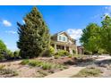 Charming two-story home with a welcoming front porch and professionally landscaped front yard at 21395 E Greenwood Pl, Aurora, CO 80013