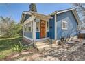 Charming entryway with a wooden door and a cozy, enclosed sunroom perfect for relaxing at 2252 S Lafayette St, Denver, CO 80210