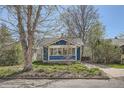 Inviting home with a sunroom, well-kept lawn, and mature trees providing shade and curb appeal at 2252 S Lafayette St, Denver, CO 80210