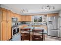 Well-lit kitchen featuring stainless steel appliances, modern fixtures, and ample counter space at 92 Helena Cir, Littleton, CO 80124