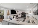 Bright living room features a fireplace, recessed lighting, and walkout to deck at 92 Helena Cir, Littleton, CO 80124