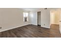 Bedroom featuring wood floors, a window with blinds, and a sliding door closet at 4866 S Dudley St # 9, Littleton, CO 80123