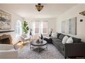 Cozy living room with an original fireplace, large windows, and comfortable seating for a relaxing atmosphere at 1615 Locust St, Denver, CO 80220