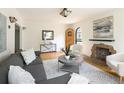 Bright living room with a decorative fireplace, hardwood floors, and stylish furniture for a cozy atmosphere at 1615 Locust St, Denver, CO 80220