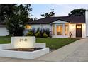 Charming home with an address marker and inviting curb appeal in a well-lit evening setting at 2941 Oneida St, Denver, CO 80207