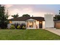 Attractive home featuring well-kept landscaping, bay window, and a painted brick chimney at 2941 Oneida St, Denver, CO 80207