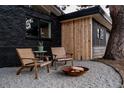 Outdoor seating area with chairs and a fire pit, set against a modern home exterior at 1560 S Forest St, Denver, CO 80222