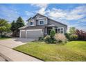 Attractive two-story house with a landscaped lawn and a two-car garage at 7696 S Hudson Way, Centennial, CO 80122