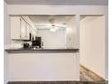 The kitchen offers countertop seating and an open view into the dining area at 2215 E Geddes Ave # P08, Littleton, CO 80122