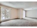 Bright living room with neutral carpet and a large window for natural light at 2215 E Geddes Ave # P08, Littleton, CO 80122