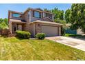 Well-maintained two-story home with an attached two-car garage and mature landscaping at 1371 W 133Rd Way, Denver, CO 80234